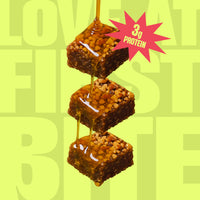 Yoga Bar Protein Date Minis close-up showing texture of nuts and dates with honey drizzle and a 3g protein per bite sticker.